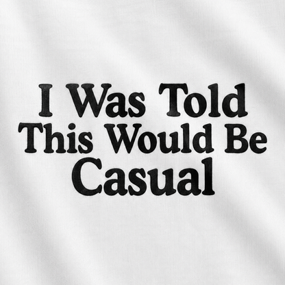 White fabric with black printed text reading 'I Was Told This Would Be Casual' in a bold serif font.